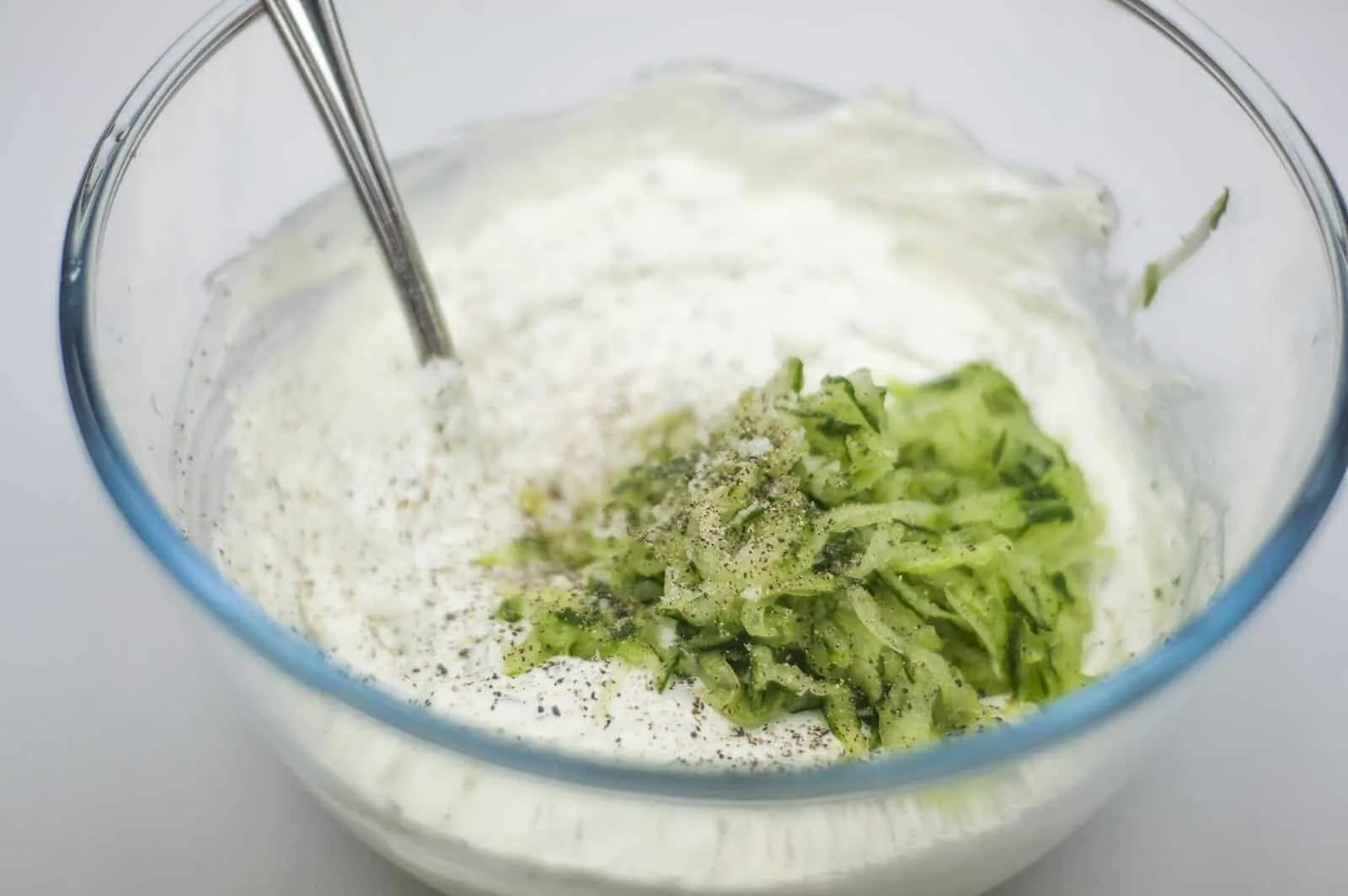 Adding the cucumber to the yogurt mix
