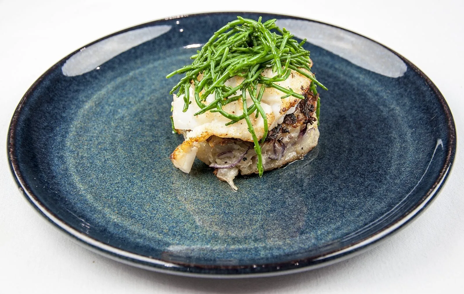 Pan fried cod with classic beurre blanc sauce. This is a fantastic recipe and very versatile with how it can be served. I placed the cod on a potato rosti and topped it with samphire. Seafood with vegetables from the sea. Yum! | https://theyumyumclub.com