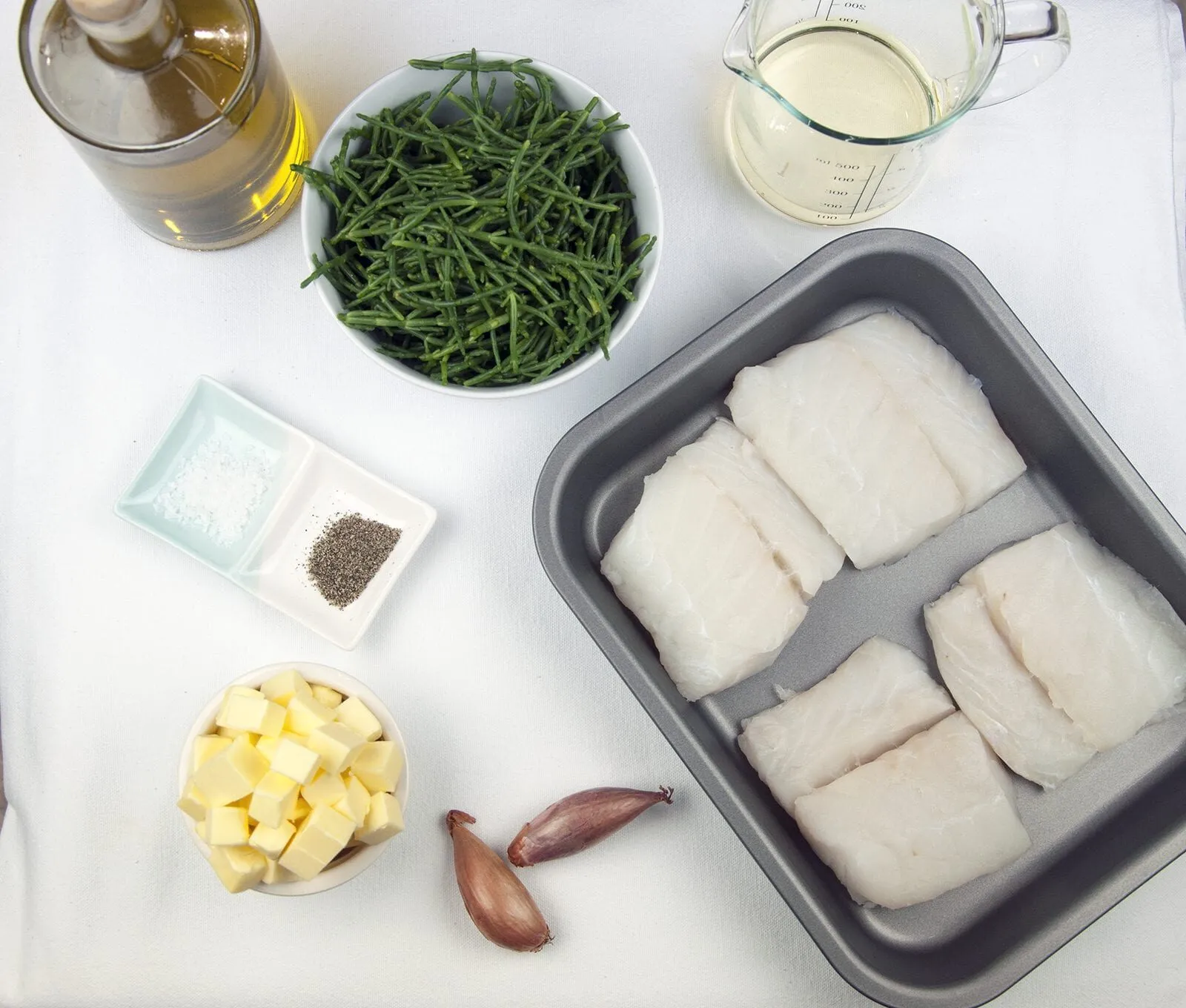 Pan fried cod with classic beurre blanc sauce. This is a fantastic recipe and very versatile with how it can be served. I placed the cod on a potato rosti and topped it with samphire. Seafood with vegetables from the sea. Yum! | https://theyumyumclub.com