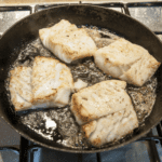 Pan fried cod with classic beurre blanc sauce. This is a fantastic recipe and very versatile with how it can be served. I placed the cod on a potato rosti and topped it with samphire. Seafood with vegetables from the sea. Yum! | https://theyumyumclub.com