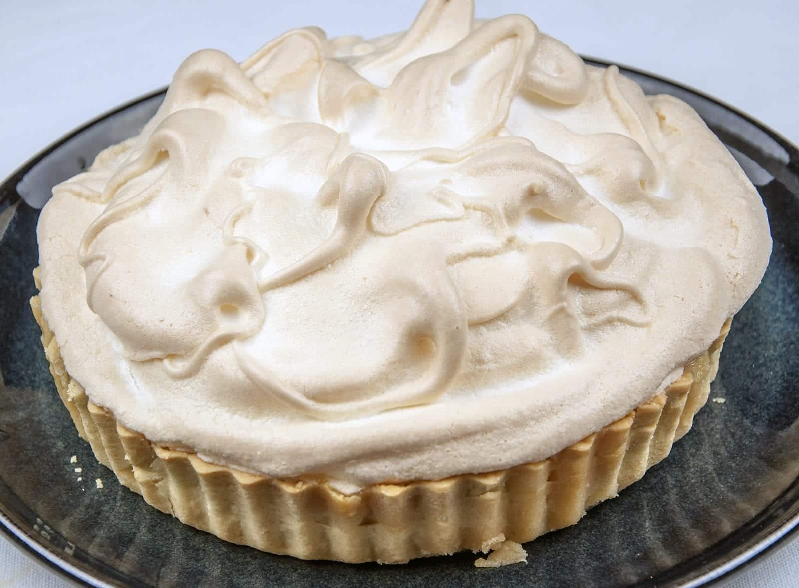 Lemon meringue pie! What a classic. Lovely sweet meringue, zesty sharp lemon, and a melt in the mouth pastry. Yummy! | https://theyumyumclub.com