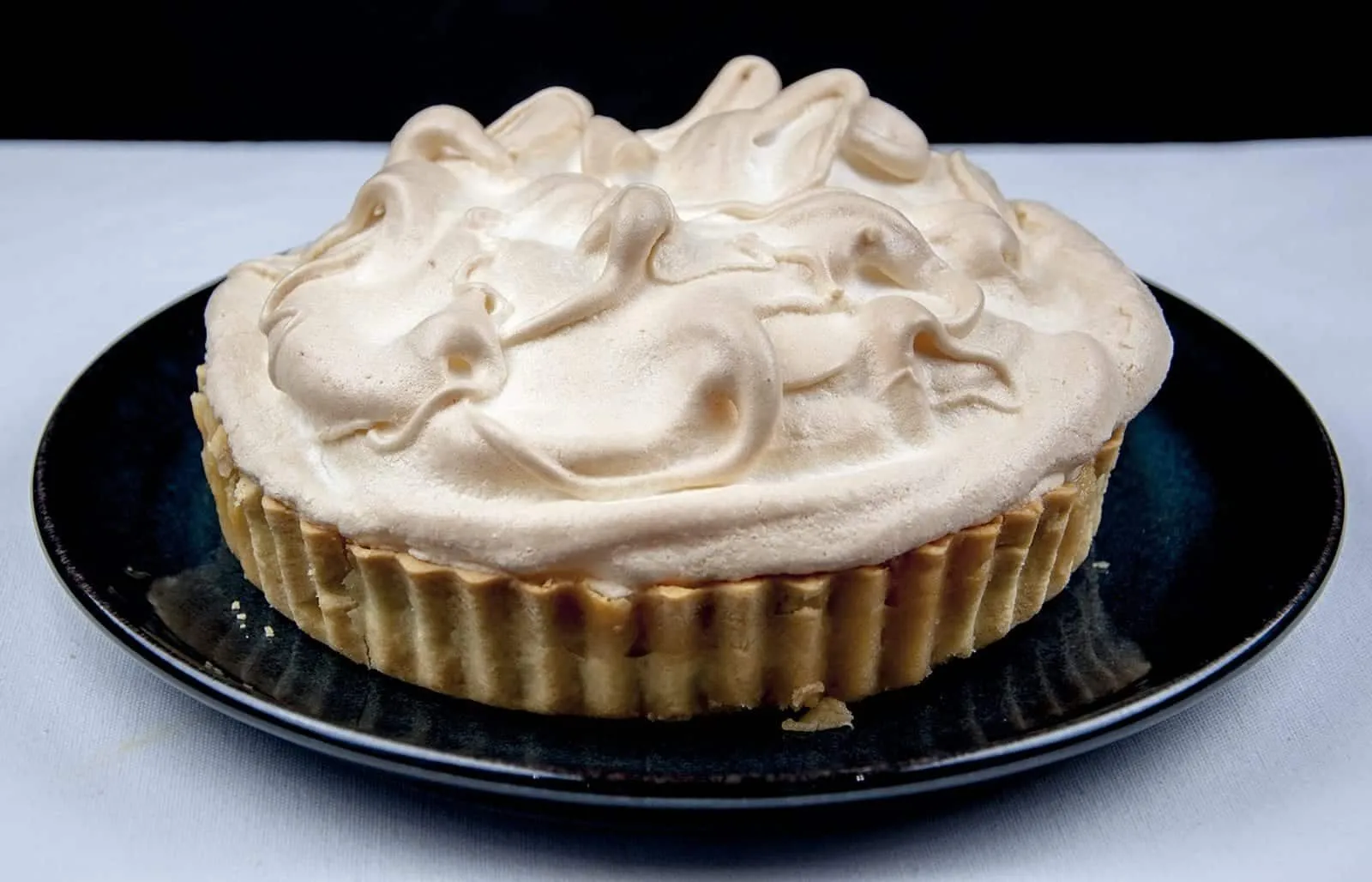Lemon meringue pie! What a classic. Lovely sweet meringue, zesty sharp lemon, and a melt in the mouth pastry. Yummy! | https://theyumyumclub.com