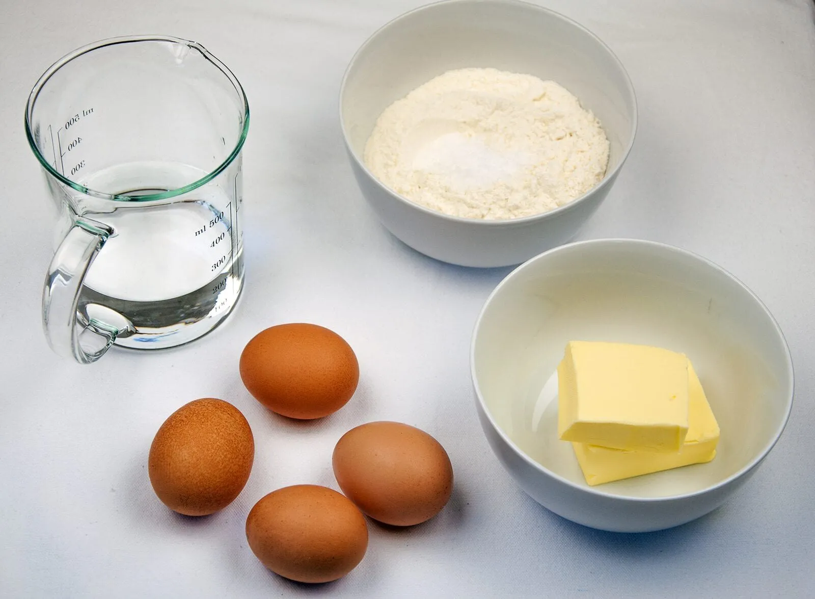 Profiteroles Recipe - How to make the finest profiteroles. Simple and easy. YOU can make them today. Choux buns, cream and chocolate! YUM! | https://theyumyumclub.com