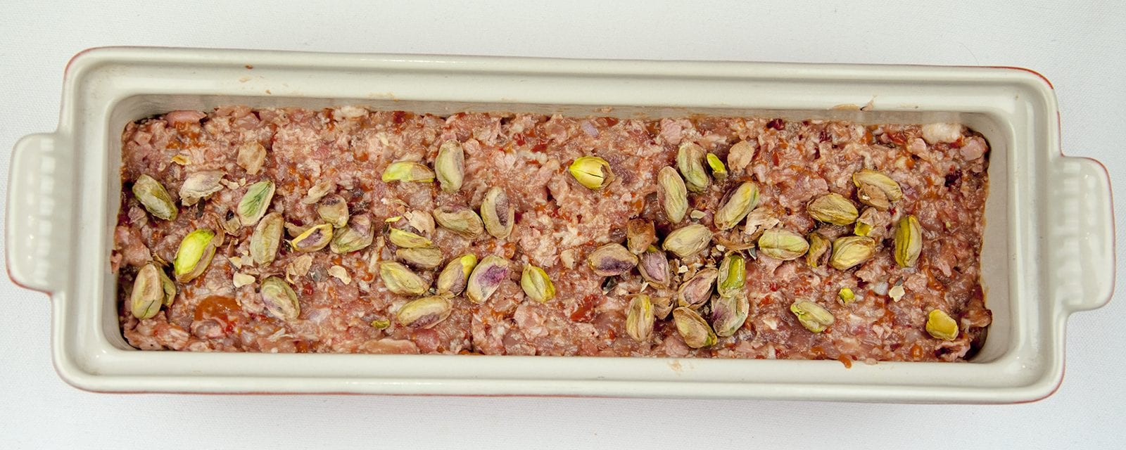 Duck, pork, cranberry and pistachio terrine. A wonderful recipe for your Christmas table. Very festive and a great appetiser before the turkey. Learn how to make this irresistible rustic farmhouse terrine. Yum Yum!! | theyumyumclub.com