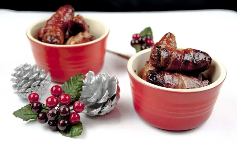 Pigs in blankets. Little pork chipolatas, wrapped in streaky bacon, and smothered in honey. The perfect accompaniment to Christmas Turkey. Yum! | theyumyumclub
