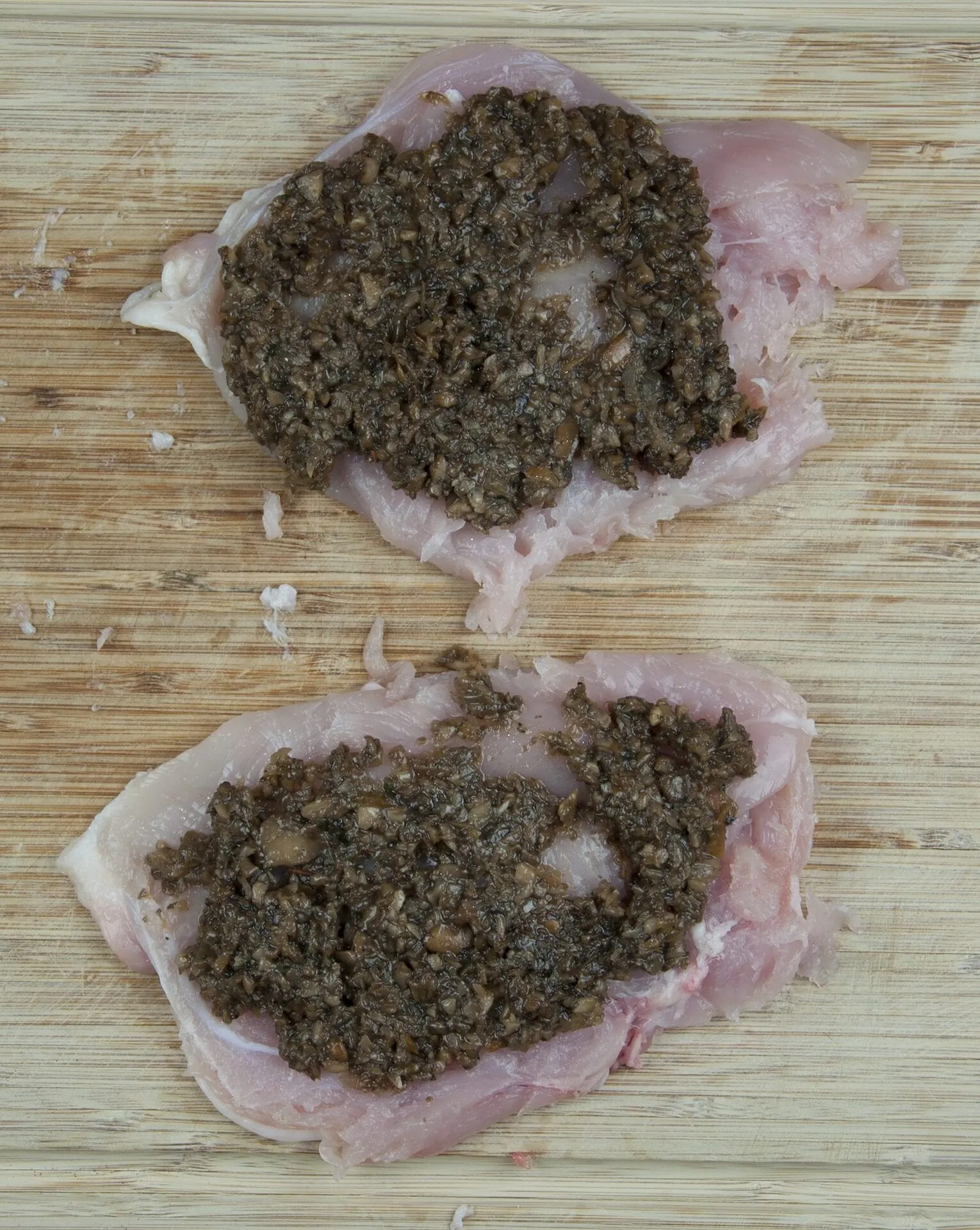 Succulent mushroom duxelle stuffed chicken breast. Pan-fried in a skillet and finished off in the oven. A wonderful, tasty and healthy chicken recipe. Yum! | theyumyumclub.com