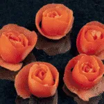 How to make tomato roses. A lovely and classy garnish for any dish. So simple to create. See how to make these pretty tomato flowers in this easy tutorial. | theyumyumclub.com