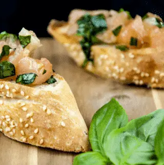 Enjoy the taste of Italy in this homemade bruschetta. Wonderful garlic, tomato concasse, basil, and extra virgin olive oil. Make the bread too if you like! | theyumyumclub.com