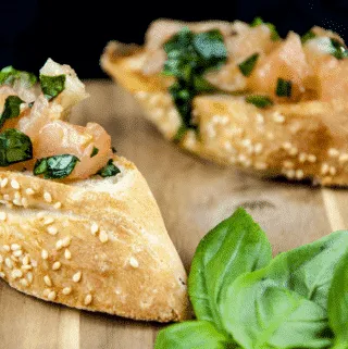 Enjoy the taste of Italy in this homemade bruschetta. Wonderful garlic, tomato concasse, basil, and extra virgin olive oil. Make the bread too if you like! | theyumyumclub.com