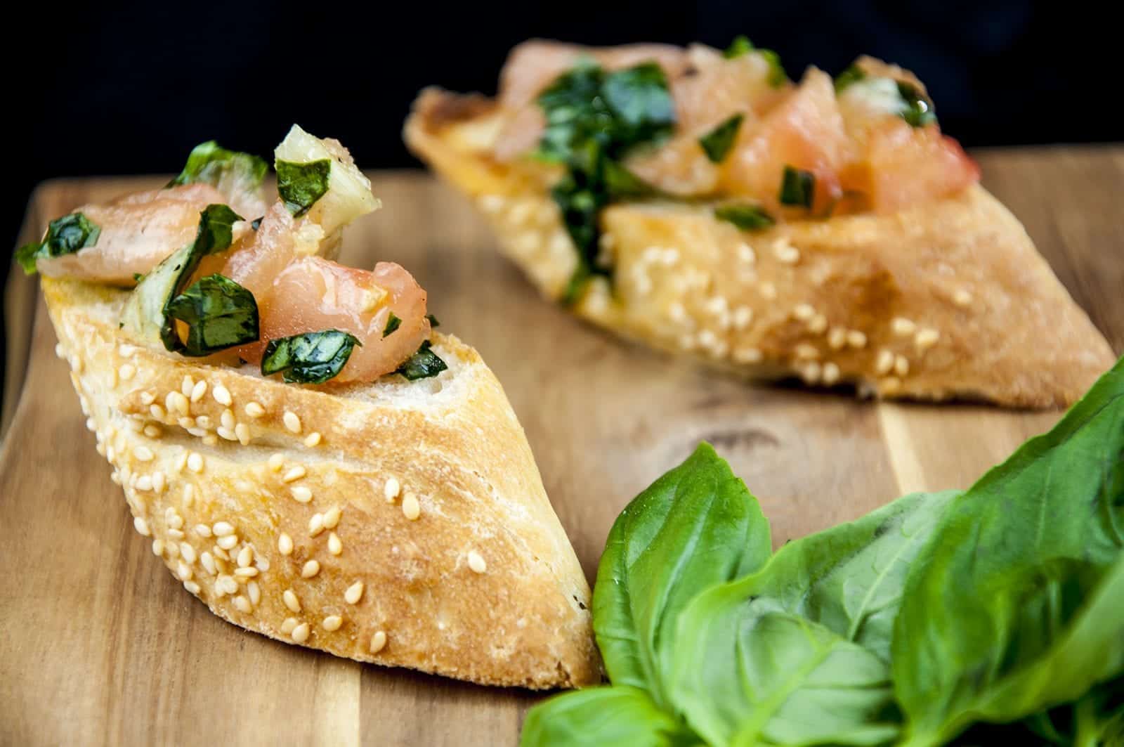 Enjoy the taste of Italy in this homemade bruschetta. Wonderful garlic, tomato concasse, basil, and extra virgin olive oil. Make the bread too if you like! | theyumyumclub.com