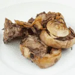 Look at these wonderfully succulent slow roasted lamb chops. Mouth-watering lamb cooked with garlic and rosemary. A midweek extravagance but why not eh? Go on, treat yourself. Yum! | theyumyumclub.com