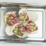 Look at these wonderfully succulent slow roasted lamb chops. Mouth-watering lamb cooked with garlic and rosemary. A midweek extravagance but why not eh? Go on, treat yourself. Yum! | theyumyumclub.com