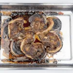 Look at these wonderfully succulent slow roasted lamb chops. Mouth-watering lamb cooked with garlic and rosemary. A midweek extravagance but why not eh? Go on, treat yourself. Yum! | theyumyumclub.com