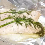 Steamed salmon in white wine. A touch of dill too. A wonderfully healthy recipe and great for lunch or dinner. 10 minutes cooking and you're done. Yum! | theyumyumclub.com