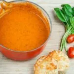 Traditional and classic tomato and basil soup. What a recipe! Tasty, creamy and at only 169 calories per serving, very healthy too!! If you miss out the scones... ???? Yum! | theyumyumclub.com