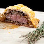 This individual beef wellington recipe is a yummy treat for one or more. Beef tenderloin, rich duxelle, and flakey puff pastry. Decadence at is best ???? | theyumyumclub.com