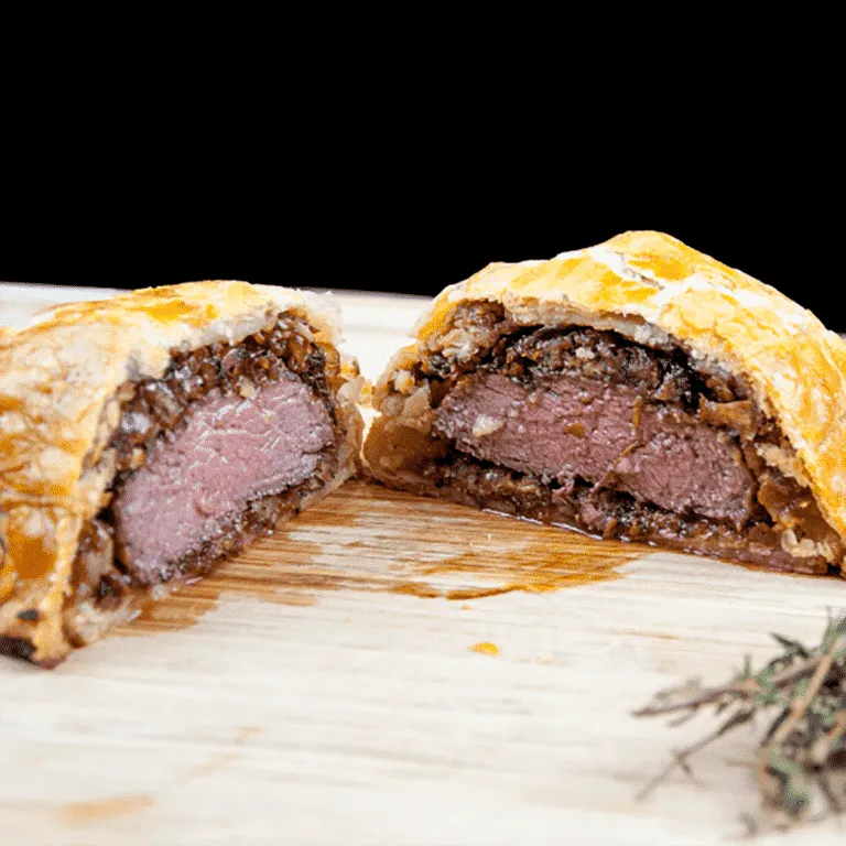 This individual beef wellington recipe is a yummy treat for one or more. Beef tenderloin, rich duxelle, and flakey puff pastry. Decadence at is best ???? | theyumyumclub.com