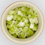 This spicy carrot, sesame and scallion salad is so simple and so healthy. 3 ingredients for the salad, 4 ingredeints for the spicy dressing, and just over 200 calories per bowl. Yum! | theyumyumclub.com