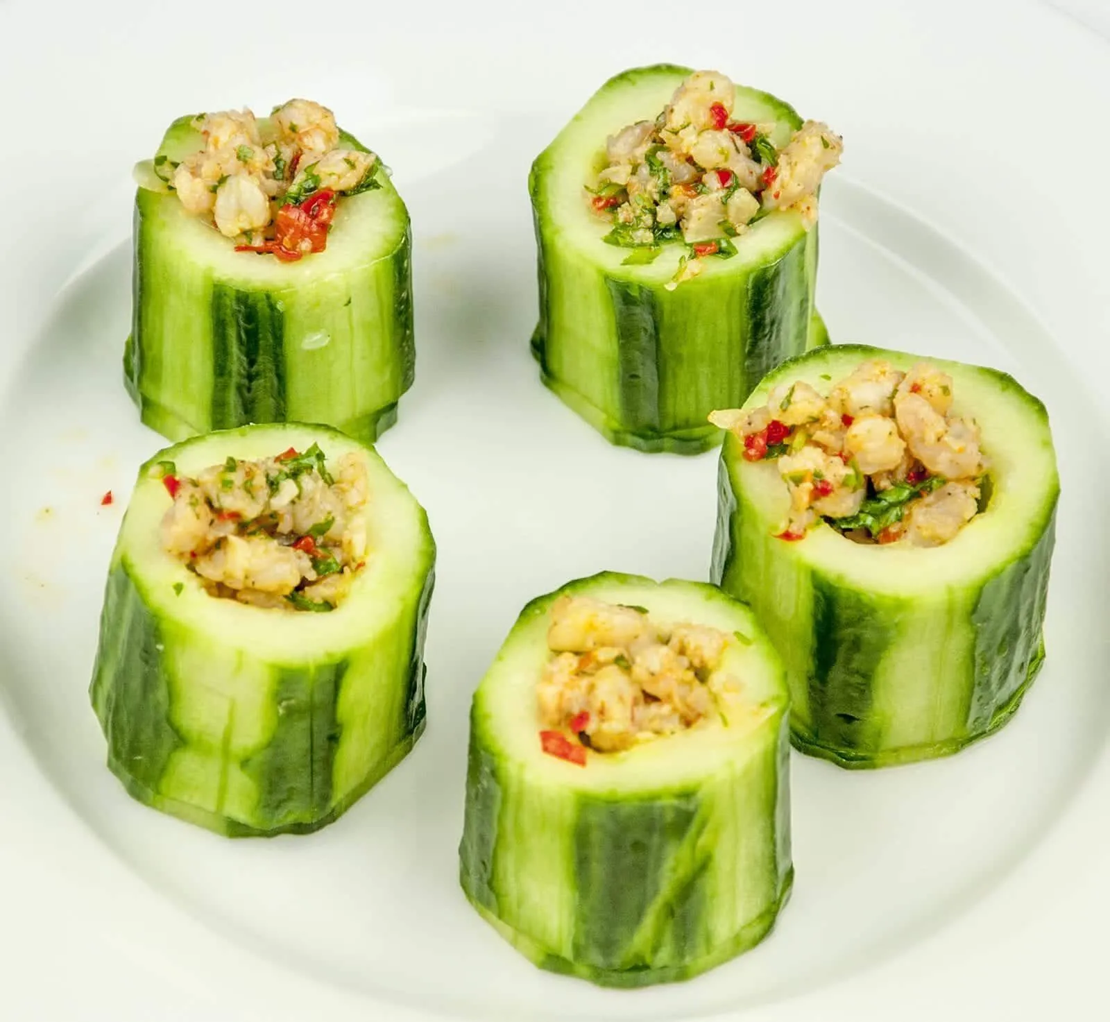Cucumber potted shrimp. Serve as a delicious appetizer for your dinner party or as a simple nibble as your guests arrive. Shrimp, garlic and chilli all served in fresh cucumber. Yum! | theyumyumclub.com