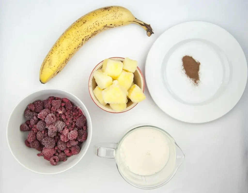 Raspberry and pineapple smoothie, with a little surprise! Banana to add texture and a wonderful hint of cinnamon to taste. A great start to the day. Yum! | theyumyumclub.com