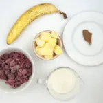 Raspberry and pineapple smoothie, with a little surprise! Banana to add texture and a wonderful hint of cinnamon to taste. A great start to the day. Yum! | theyumyumclub.com
