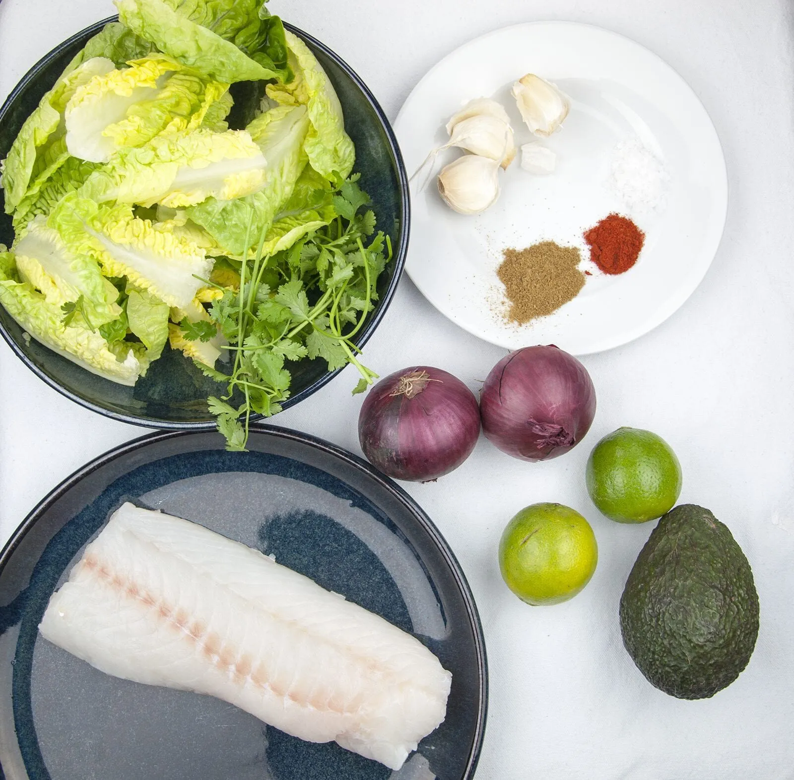 Spicy codfish tacos. How tasty do these sound? Fresh cod fish smothered in cumin and paprika wrapped in a tortilla with red onion, lime and coriander. Yum! | theyumyumclub.com