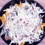 We all know pulled pork nachos but how about tangy pulled pork shoulder Doritos! Tangy cheese Doritos covered in spicy slow-cooked pork shoulder drowned in melted cheddar cheese. Yum! | theyumyumclub.com