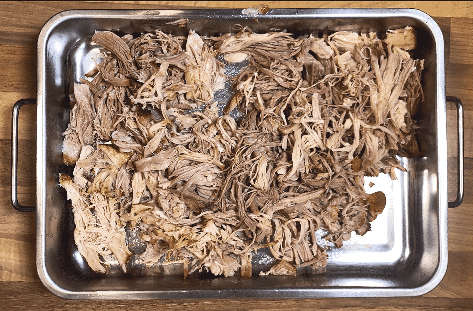 We all know pulled pork nachos but how about tangy pulled pork shoulder Doritos! Tangy cheese Doritos covered in spicy slow-cooked pork shoulder drowned in melted cheddar cheese. Yum! | theyumyumclub.com