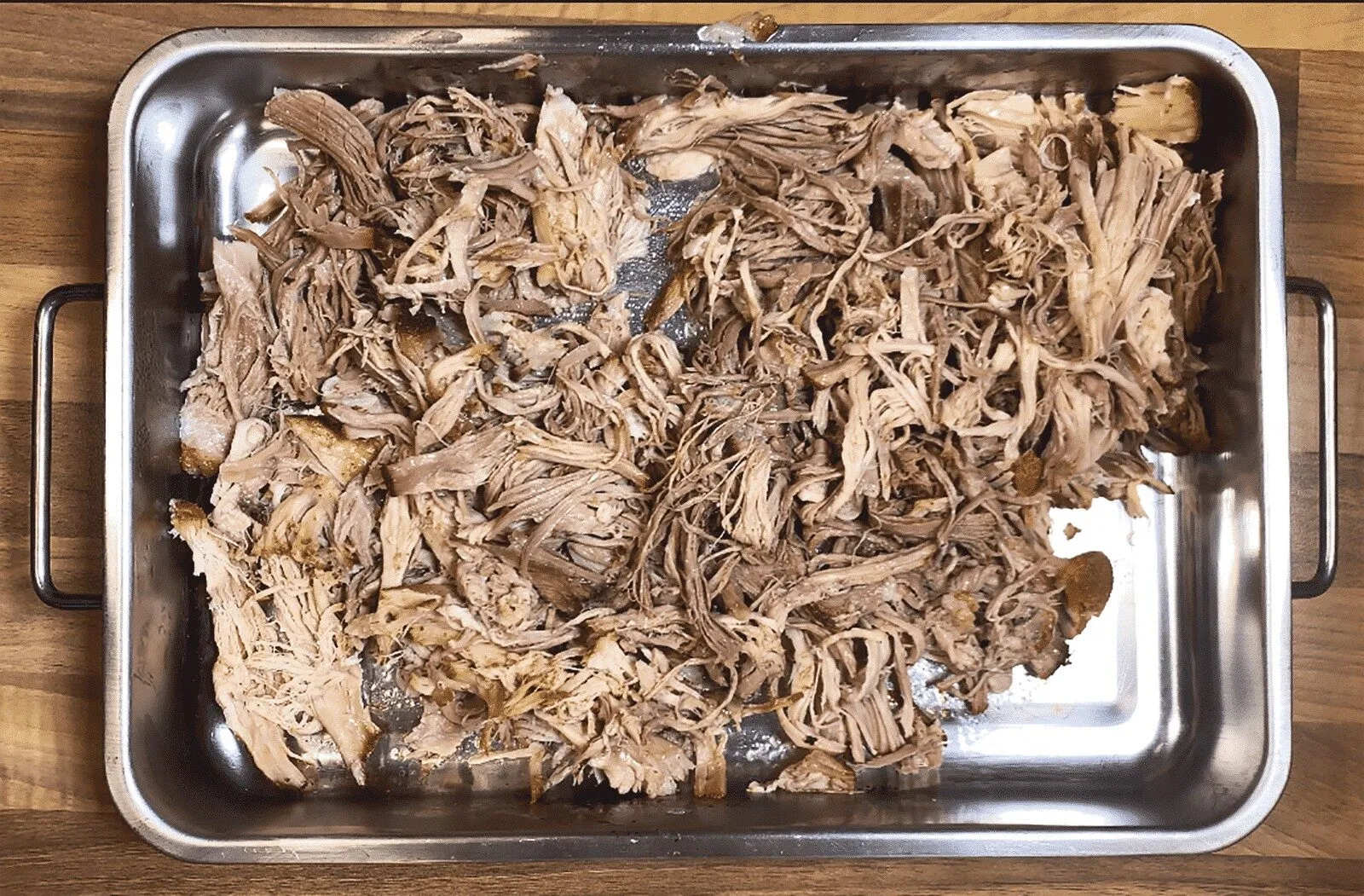 We all know pulled pork nachos but how about tangy pulled pork shoulder Doritos! Tangy cheese Doritos covered in spicy slow-cooked pork shoulder drowned in melted cheddar cheese. Yum! | theyumyumclub.com