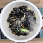 Linguine with mussels, scallops and garlic in white wine and cream is a classic Italian recipe. Serve with fresh crusty bread for dipping. Yum! | theyumyumclub.com