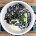 Linguine with mussels, scallops and garlic in white wine and cream is a classic Italian recipe. Serve with fresh crusty bread for dipping. Yum! | theyumyumclub.com