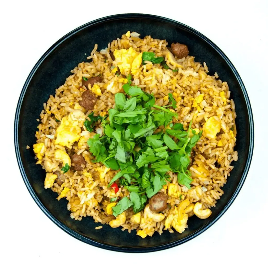 This Thai style sausage fried rice is a fusion of the best from East and West. Cashews, chilli, garlic, basil, coriander and sweet smelling saffron. Yum! | theyumyumclub.com