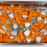Mix the vegetables and oil together | https://theyumyumclub.com/2019/04/22/braised-carrot-pearl-barley-salad/