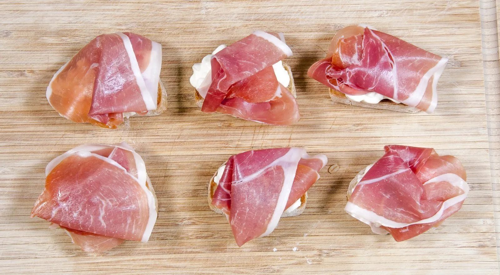 Layer the prosciutto | https://theyumyumclub.com/2019/04/23/ricotta-prosciutto-fig-crostini/