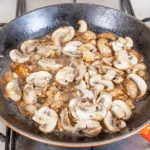 Creamy sherry and thyme chicken thighs. A wonderfully mouthwatering and delicious recipe. Add in wild mushrooms and you have one very special dish. Yum! | theyumyumclub.com