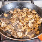 Creamy sherry and thyme chicken thighs. A wonderfully mouthwatering and delicious recipe. Add in wild mushrooms and you have one very special dish. Yum! | theyumyumclub.com