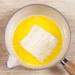 Parmesan & Paprika Haddock Baked in Garlic Butter. Dip the fish in the butter | https://theyumyumclub.com/2019/04/29/parmesan-paprika-haddock-garlic-butter/