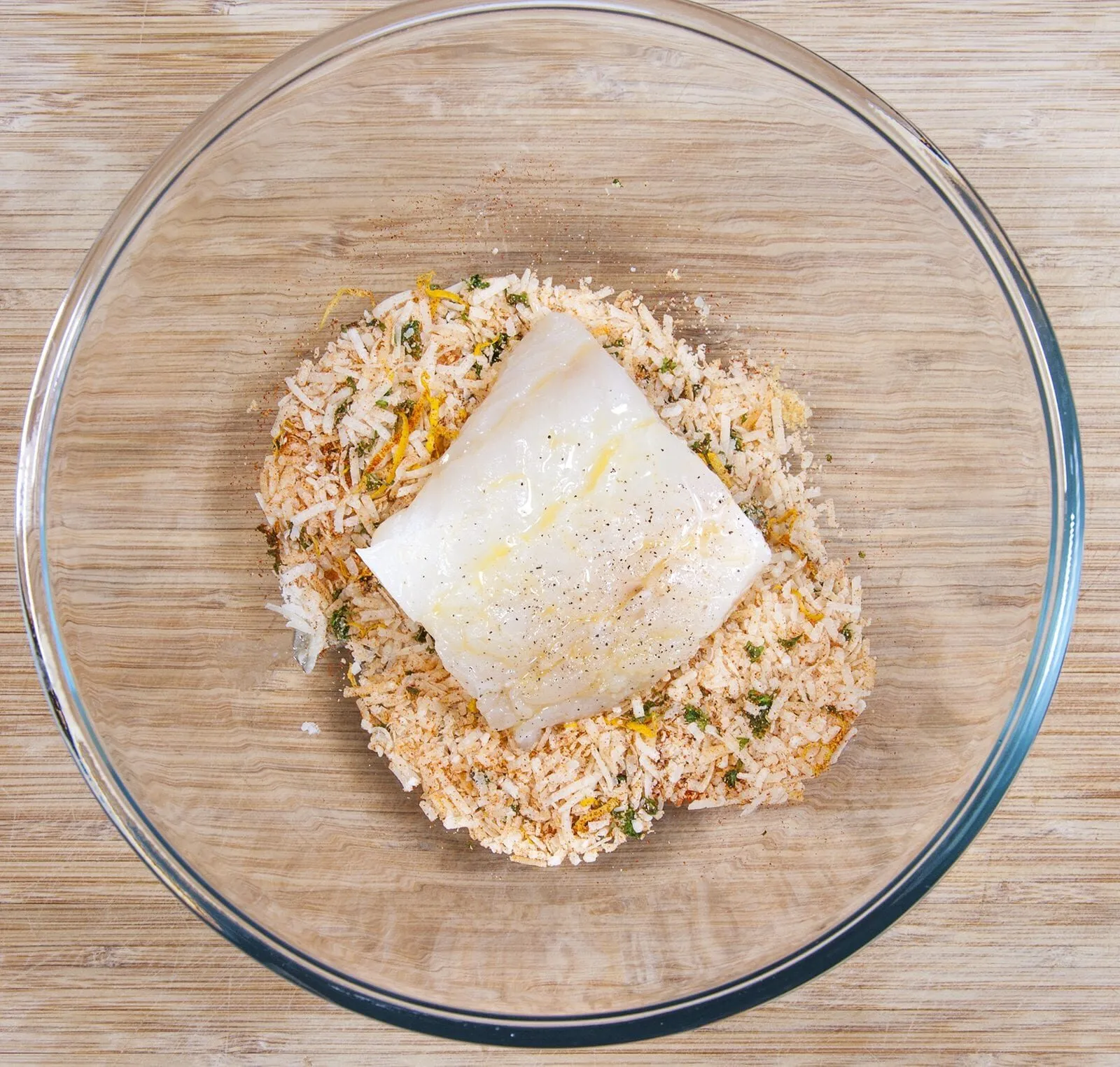 Parmesan & Paprika Haddock Baked in Garlic Butter. Dip the fish in the coating | https://theyumyumclub.com/2019/04/29/parmesan-paprika-haddock-garlic-butter/
