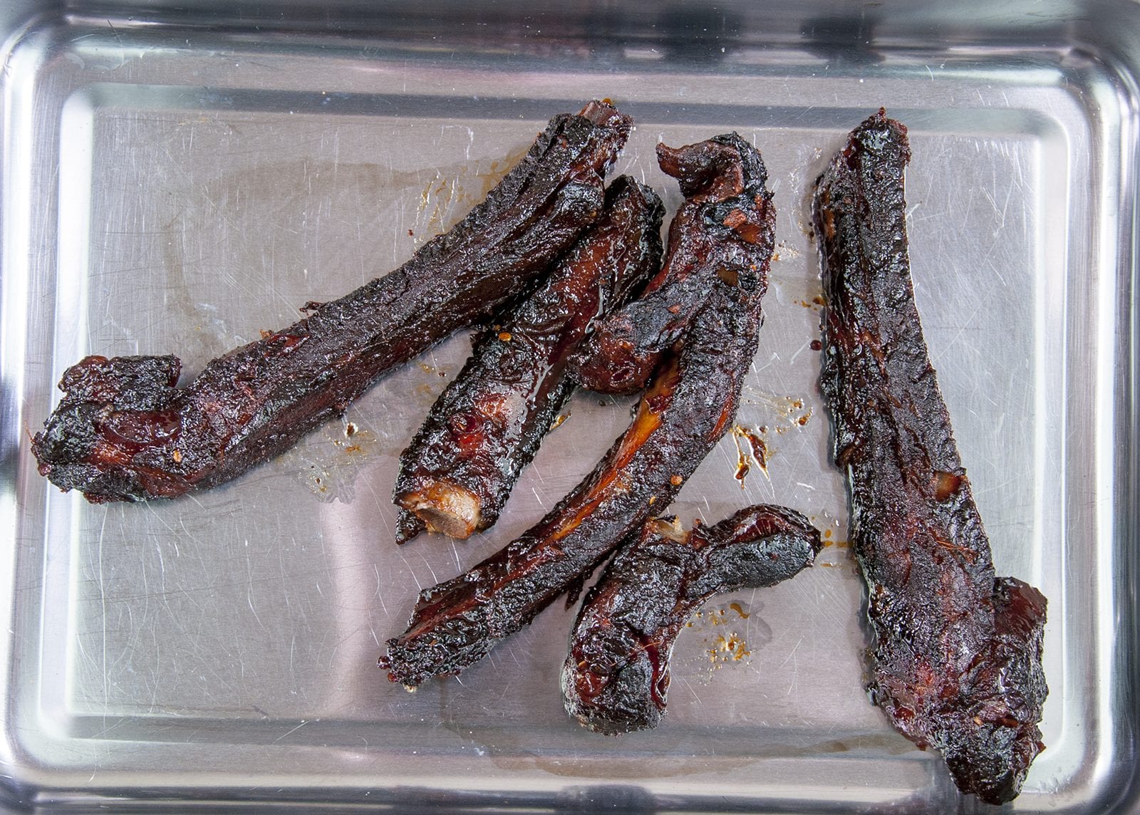 Place the cooked ribs in a roasting tray. Chinese sticky hoisin chilli ribs. Perfect pork spare rib. Yum! Yum! | theyumyumclub.com
