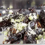 Once caramelised add sesame and spring onions. Chinese sticky hoisin chilli ribs. Perfect pork spare rib. Yum! Yum! | theyumyumclub.com