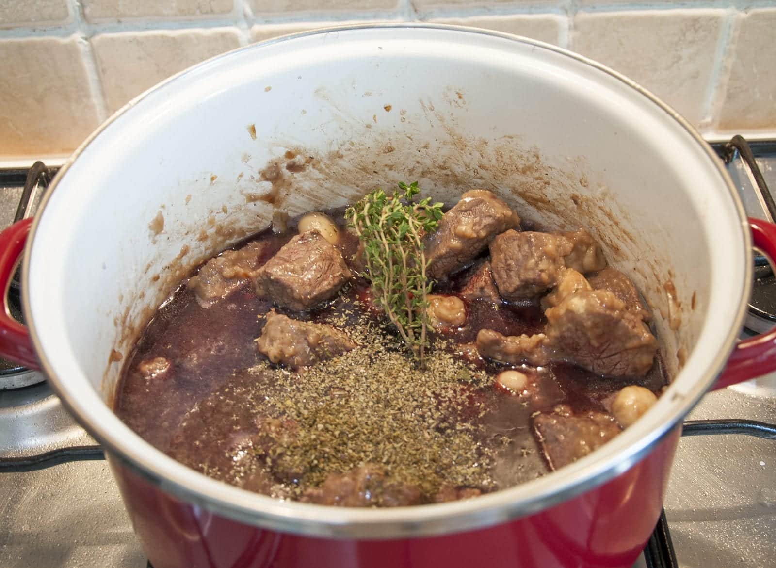 Braised beef rump in red wine. Add the thyme and mixed herbs | https://theyumyumclub.com/2019/05/08/braised-beef-rump-red-wine/