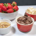 Hazelnut and chocolate smothered strawberries. Get the ingredients together | https://theyumyumclub.com/2019/05/21/hazelnut-chocola…red-strawberries/
