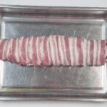 Streaky & apple pork tenderloin. Place in a roasting tray | https://theyumyumclub.com/2019/05/19/streaky-apple-pork-tenderloin/