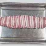 Streaky & apple pork tenderloin. Place in a roasting tray | https://theyumyumclub.com/2019/05/19/streaky-apple-pork-tenderloin/