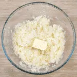 Cheddar topped shepherd's pie. Add the butter and milk to the potatoes | https://theyumyumclub.com/2019/05/16/cheddar-topped-shepherds-pie/