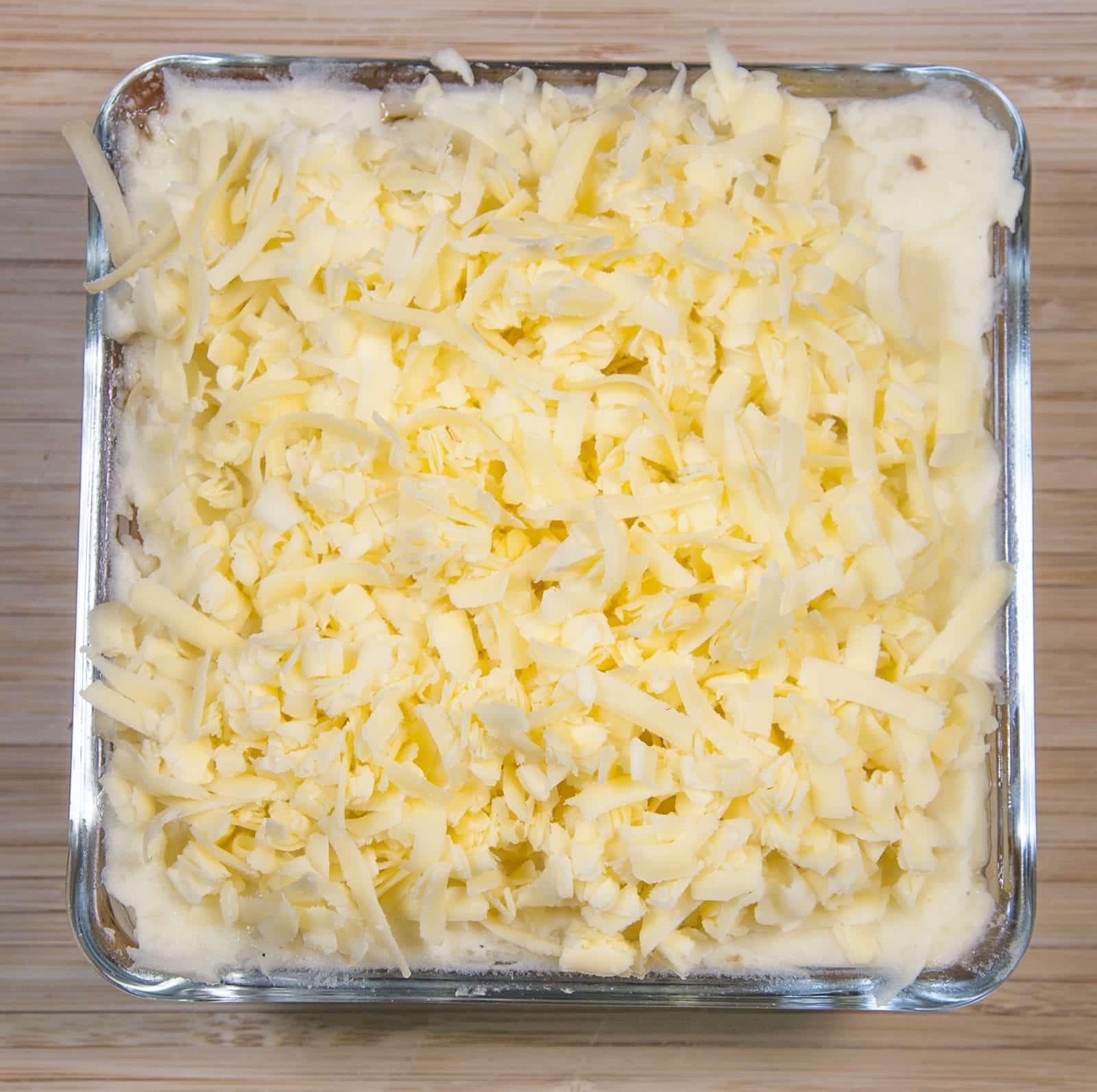 Cheddar topped shepherd's pie. Add the grated cheese | https://theyumyumclub.com/2019/05/16/cheddar-topped-shepherds-pie/