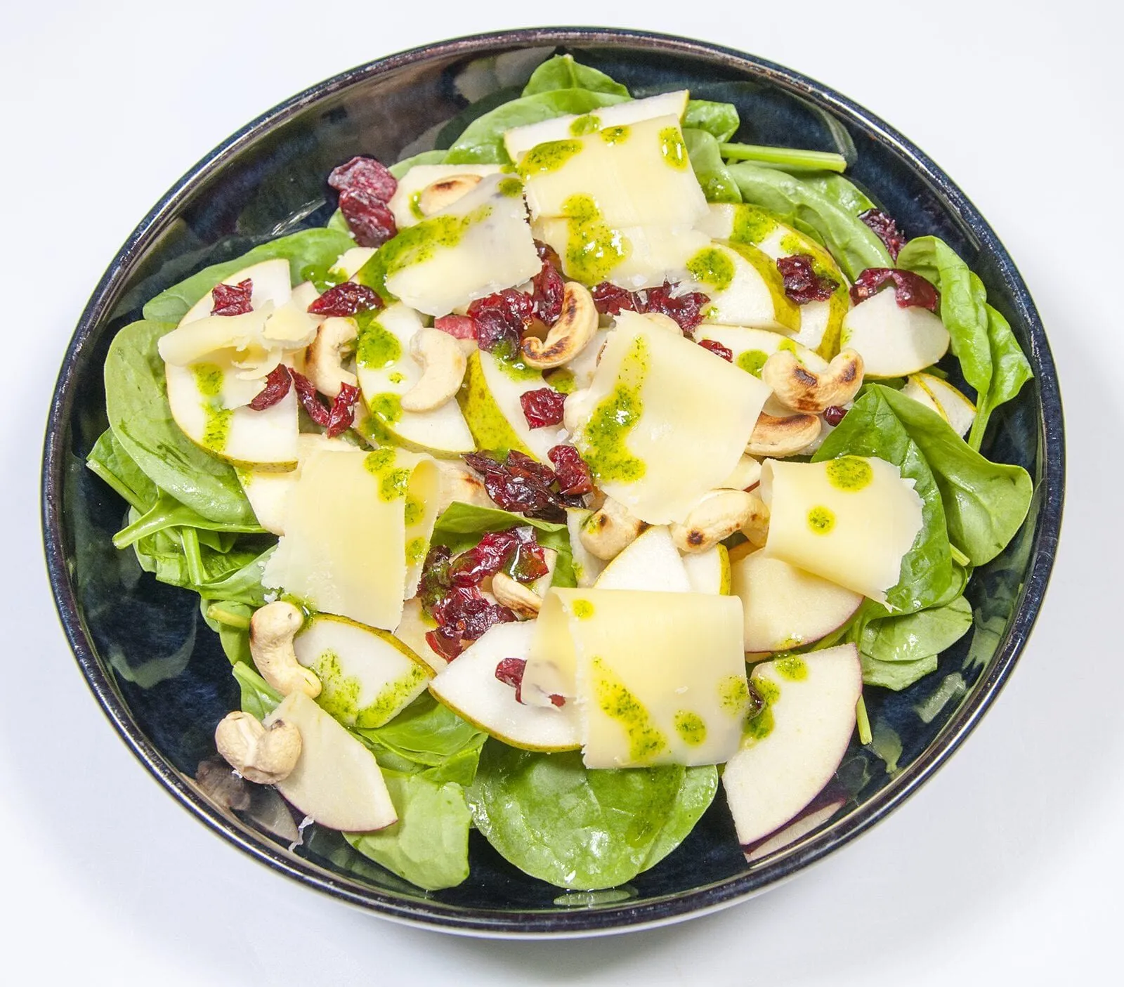 Drizzle the dressing | https://theyumyumclub.com/2019/06/10/cashew-cranberry-comte-fruit-salad/