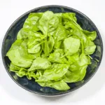Lay out the salad leaves | https://theyumyumclub.com/2019/06/10/cashew-cranberry-comte-fruit-salad/
