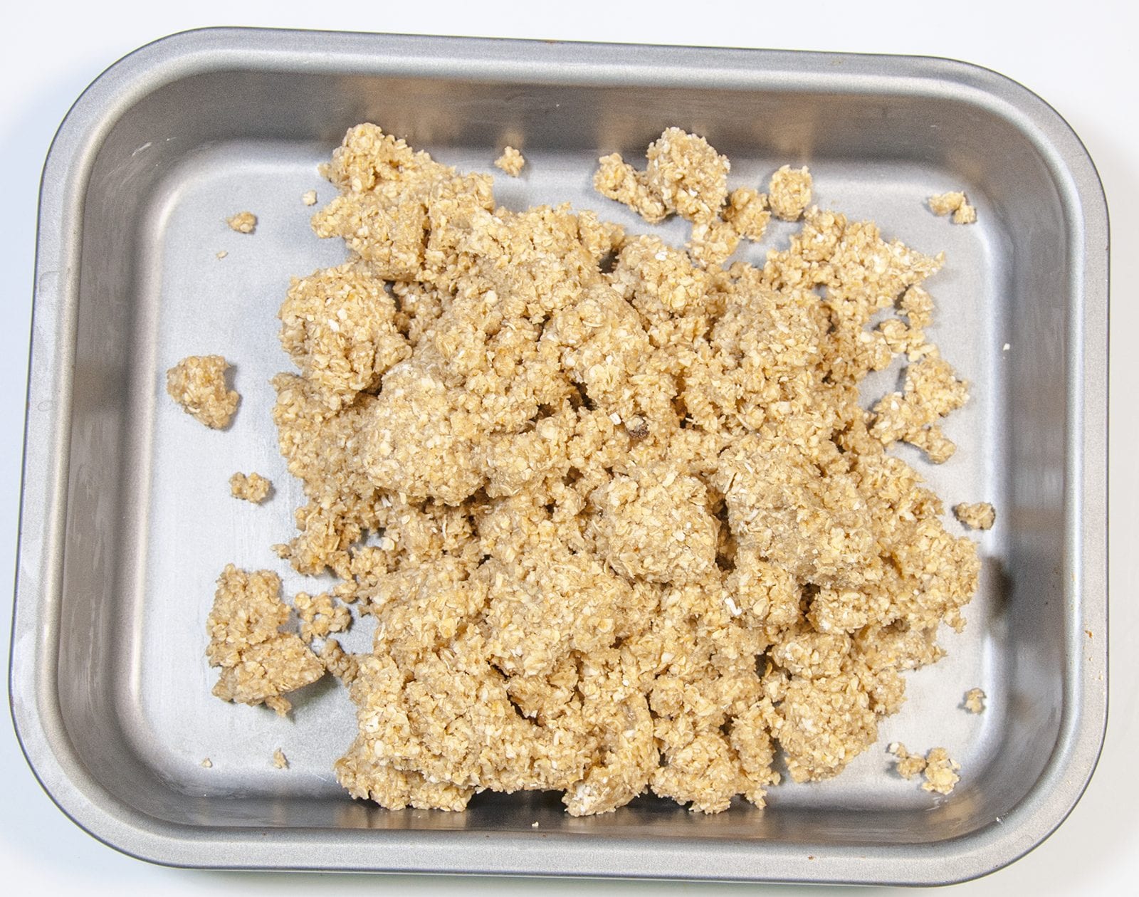 Tip the flapjack mixture into a baking tray | https://theyumyumclub.com/2019/06/01/extra-soft-and-chewy-flapjacks/