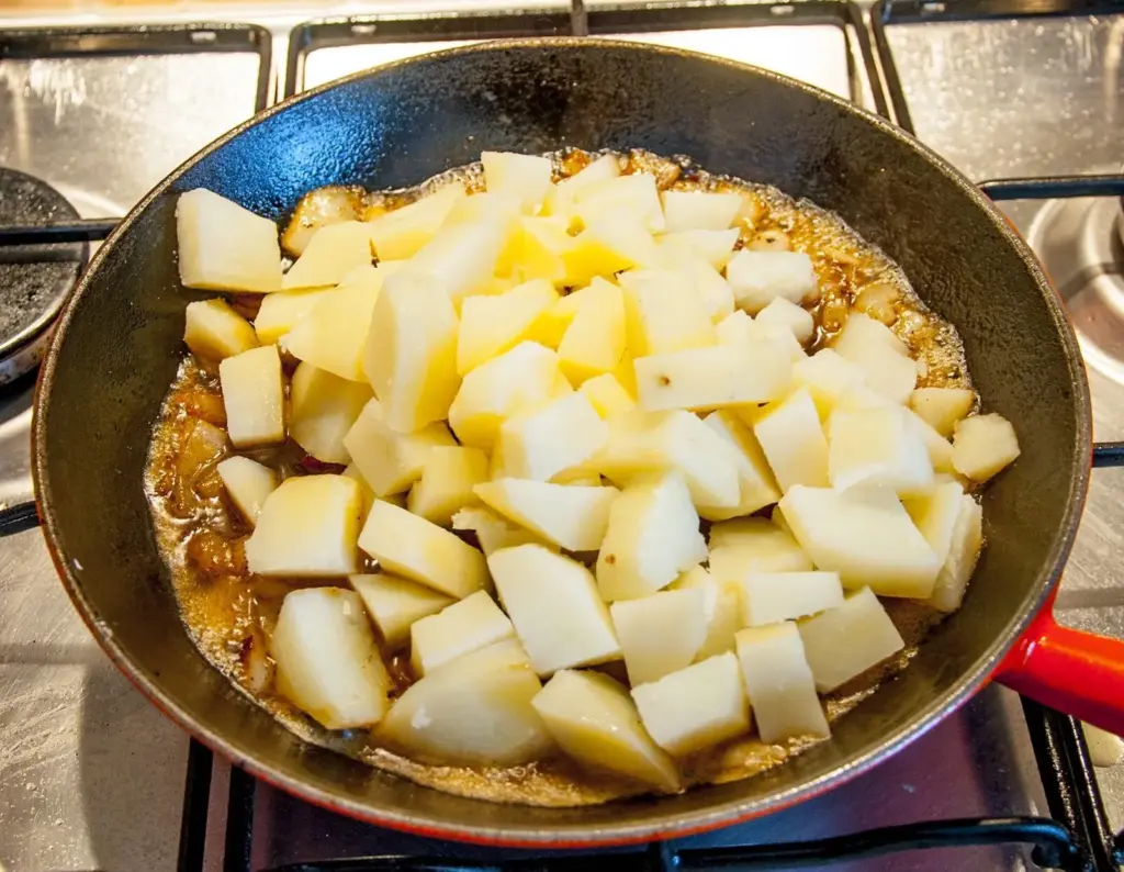 Add the potatoes | https://theyumyumclub.com/2019/06/24/bavarian-potato-salad-bacon/